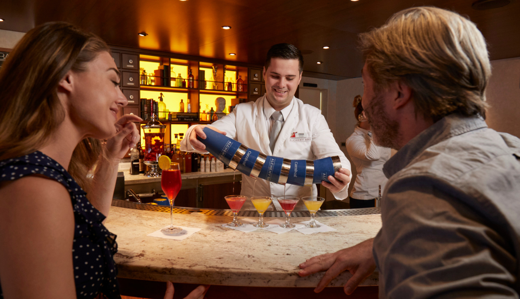 Couple being served colourful drinks at Alchemy Bar