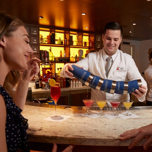 Couple being served colourful drinks at Alchemy Bar