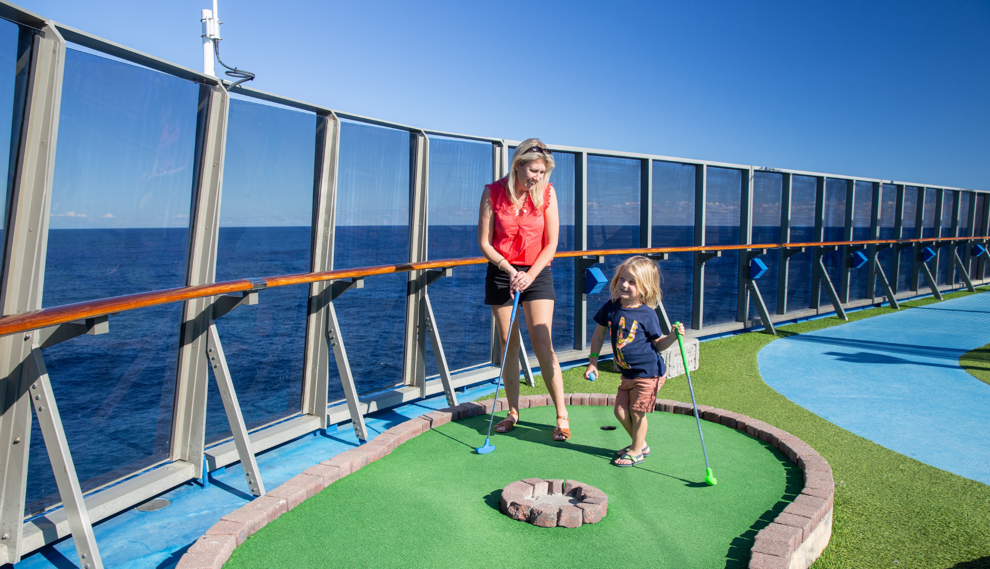 Guests playing a round of mini golf on top deck