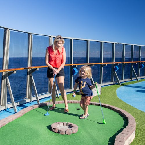 Guests playing a round of mini golf on top deck