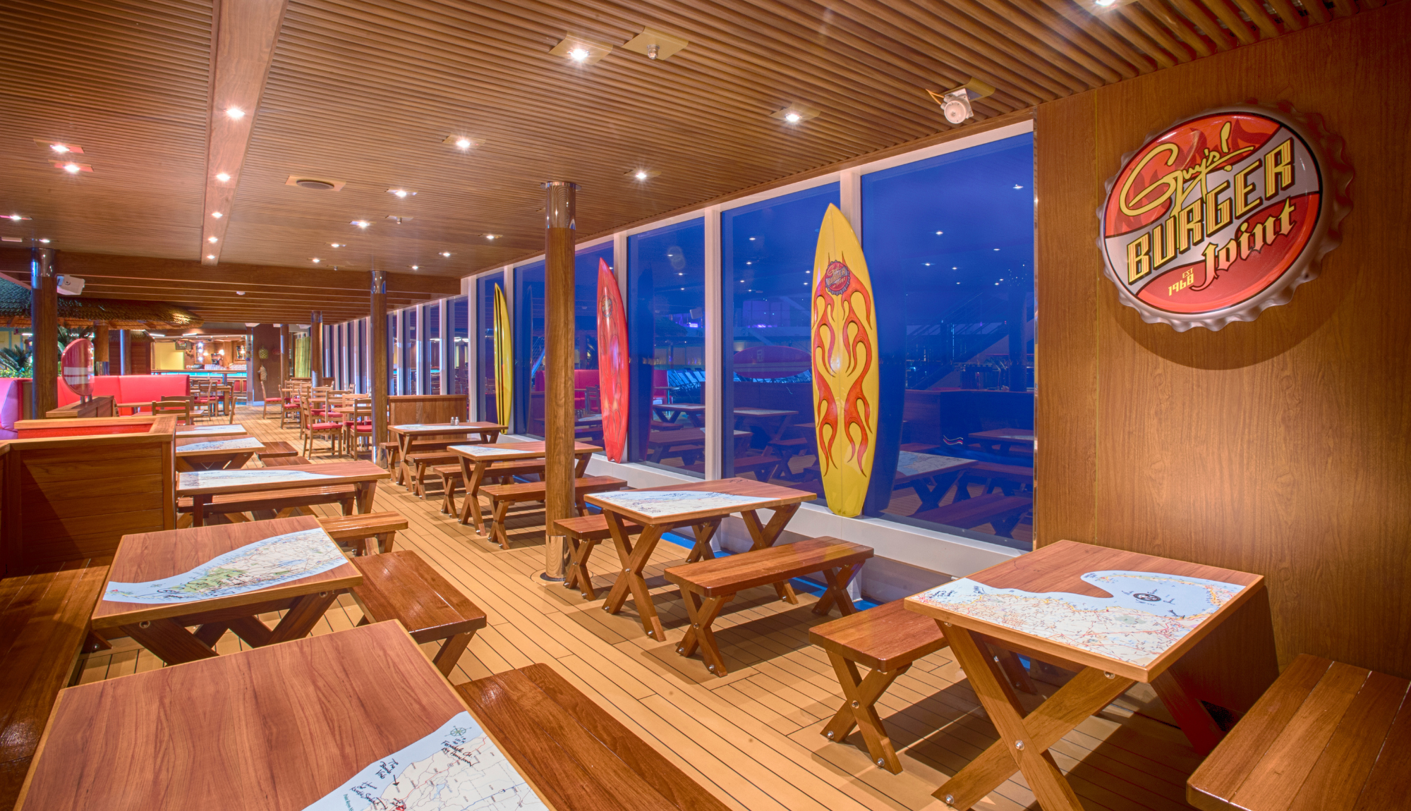 Tables set at Guys Burger Joint with views of the ocean