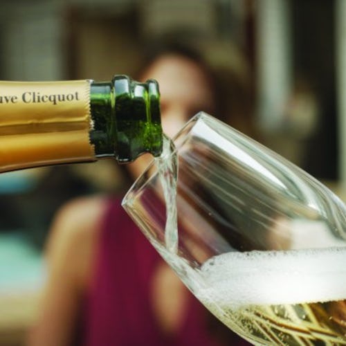 A butler pouring champagne for a Haven guest