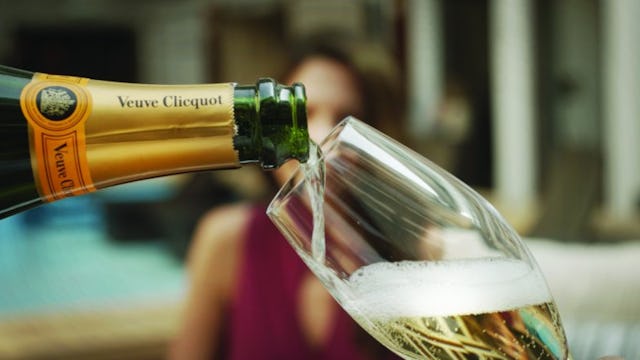 A butler pouring champagne for a Haven guest