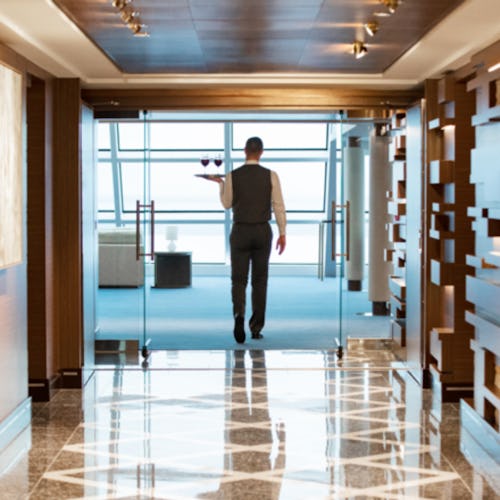A waiter bringing wine to Haven guests