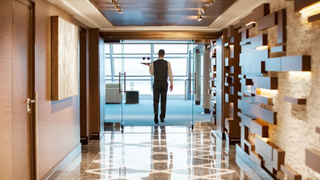 A waiter bringing wine to Haven guests