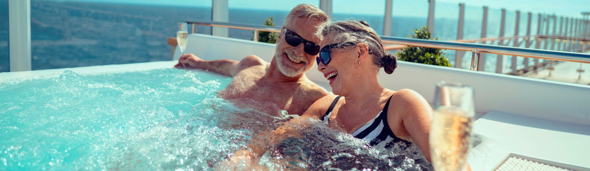 A couple enjoying champagne in a hot tub