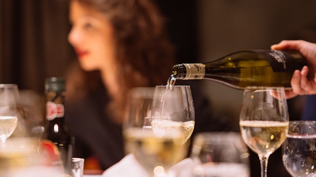 Waiter pouring wine at dinner onboard AmaWaterways