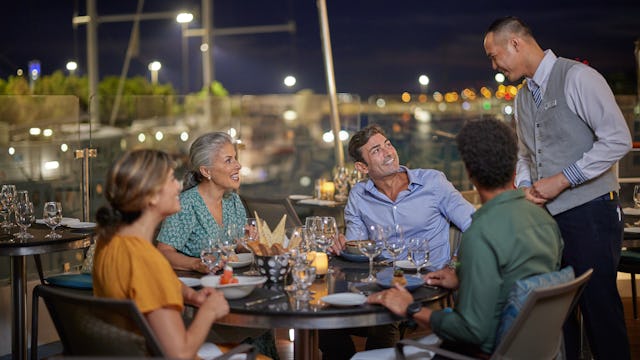 Guests onboard Windstar Cruises enjoying dinner at Candles Restaurant