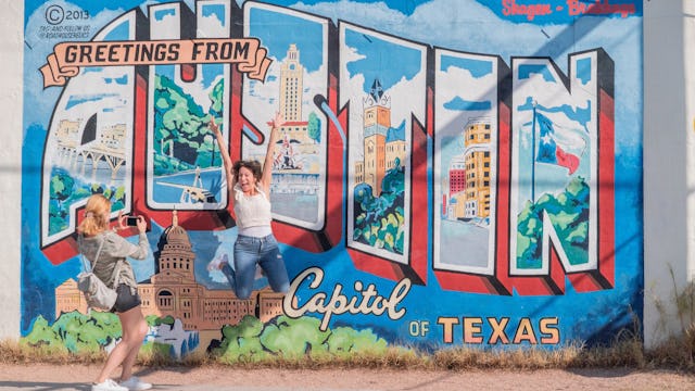Paramount Cruises customers taking pictures in front of an Austin mural