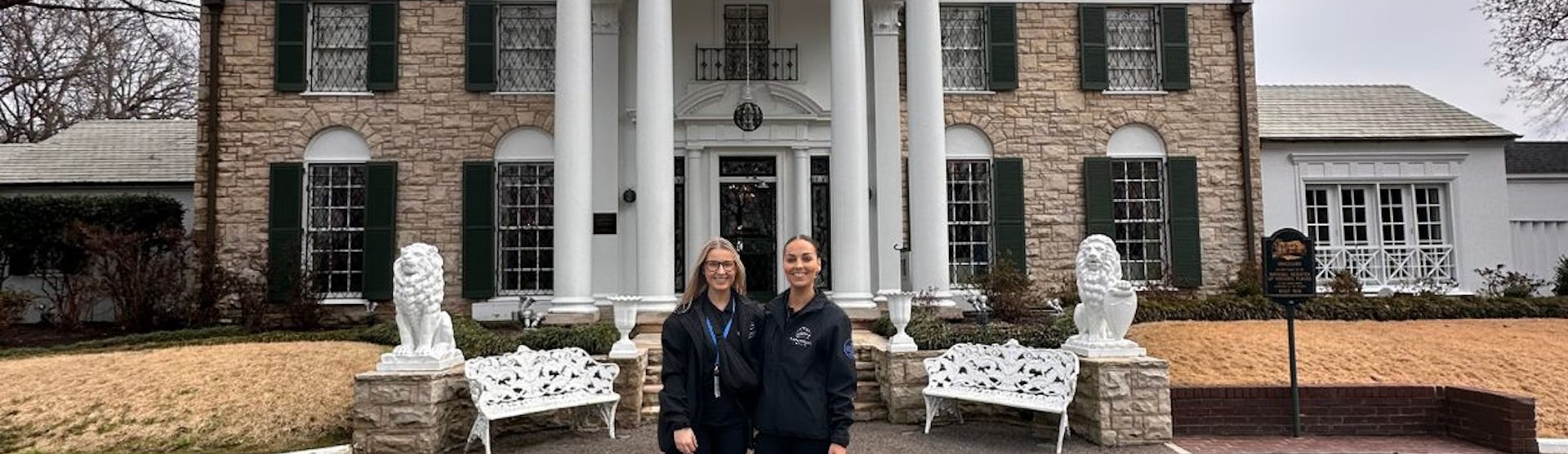 Leah and Jess from Paramount Cruises outside of Elvis Presley's Graceland mansion