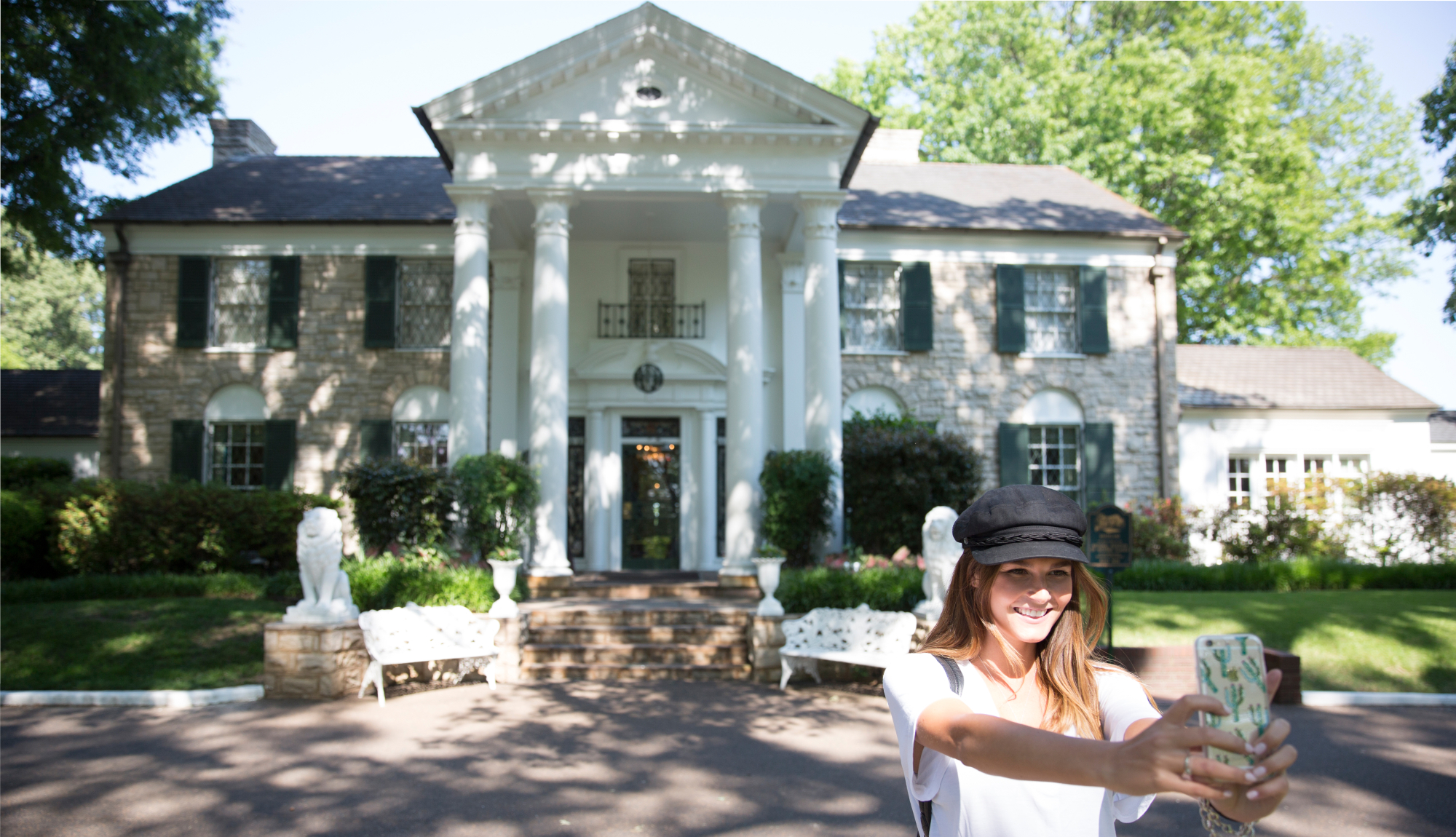 A Paramount Cruises customer taking a selfie outside Elvis Presley's Graceland mansion, in Memphis