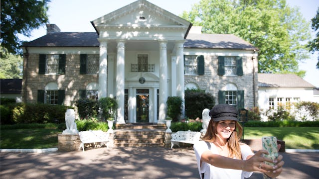 A Paramount Cruises customer taking a selfie outside Elvis Presley's Graceland mansion, in Memphis