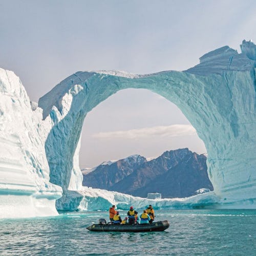 Zodiac boat in Antarctica showing an ice arch formation
