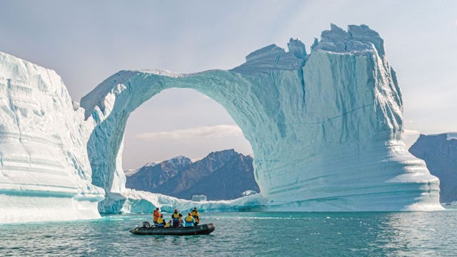 Zodiac boat in Antarctica showing an ice arch formation