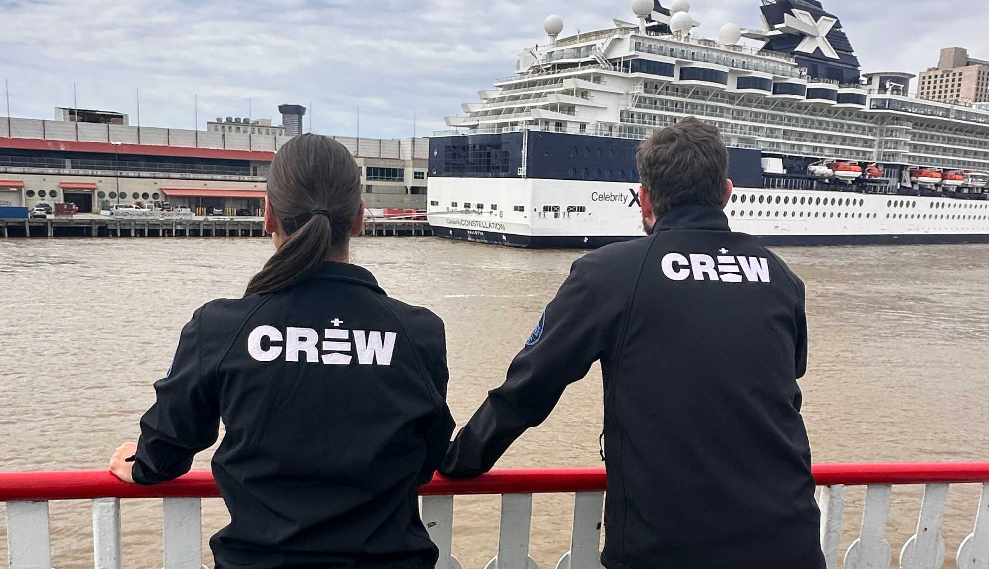 Leah & Patrick looking out over the Mississippi towards a Celebrity Cruises ship