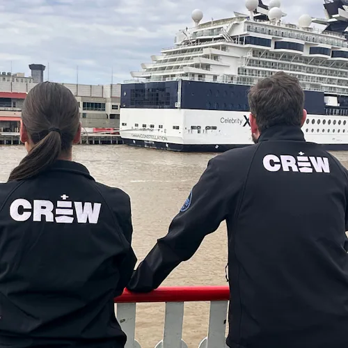 Leah & Patrick looking out over the Mississippi towards a Celebrity Cruises ship