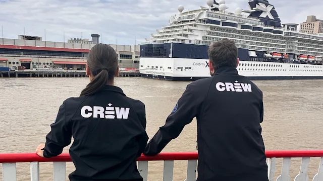 Leah & Patrick looking out over the Mississippi towards a Celebrity Cruises ship