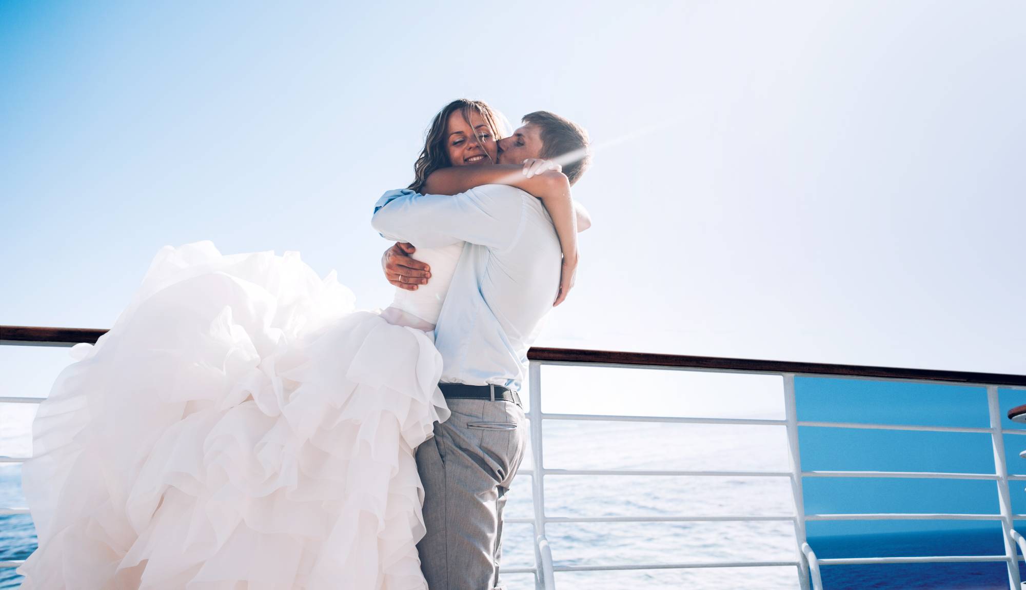 Weddings at Sea - Couple hugging on deck just married