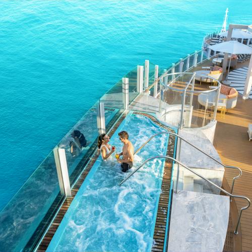 Escape to Vibe Beach Club, an adults-only retreat with comfortable loungers, a full-service bar, infinity hot tubs and sweeping views across the ocean.