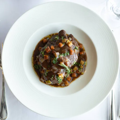 Crystal Cruises - Osteria d'Ovidio - Osso Bucco Veal Shank Braised in its Own Jus, Root Vegetables, Tomato & Fresh Herbs, Served with Mascarpone Polenta 2