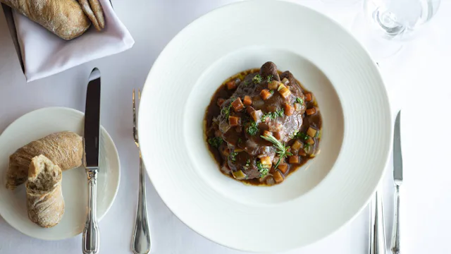 Crystal Cruises - Osteria d'Ovidio - Osso Bucco Veal Shank Braised in its Own Jus, Root Vegetables, Tomato & Fresh Herbs, Served with Mascarpone Polenta 2
