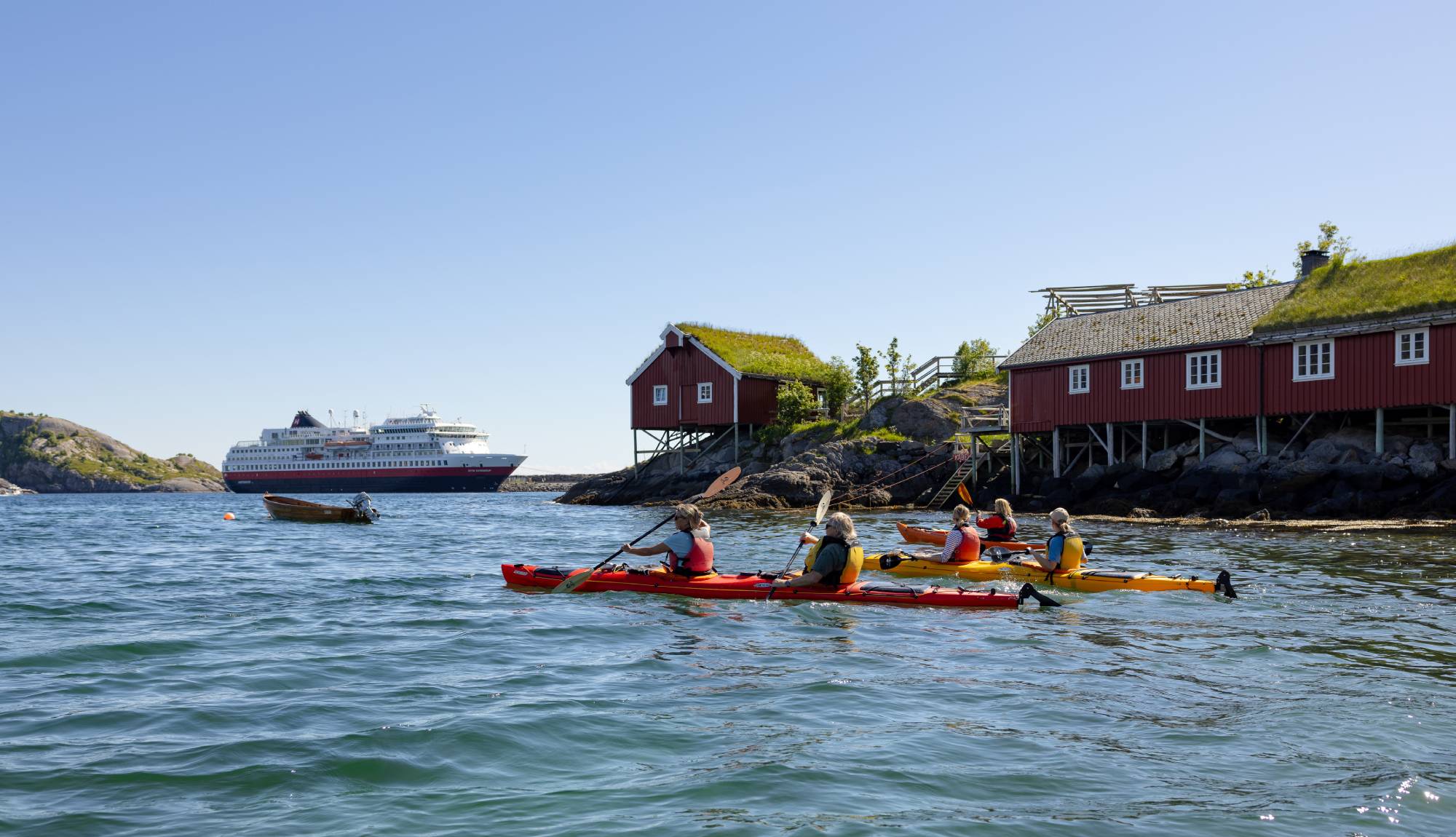 Hurtigruten -  Group of people kayaking in Reine
