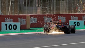 Max Verstappen's Red Bull with sparks flying at the Circuit de Catalunya