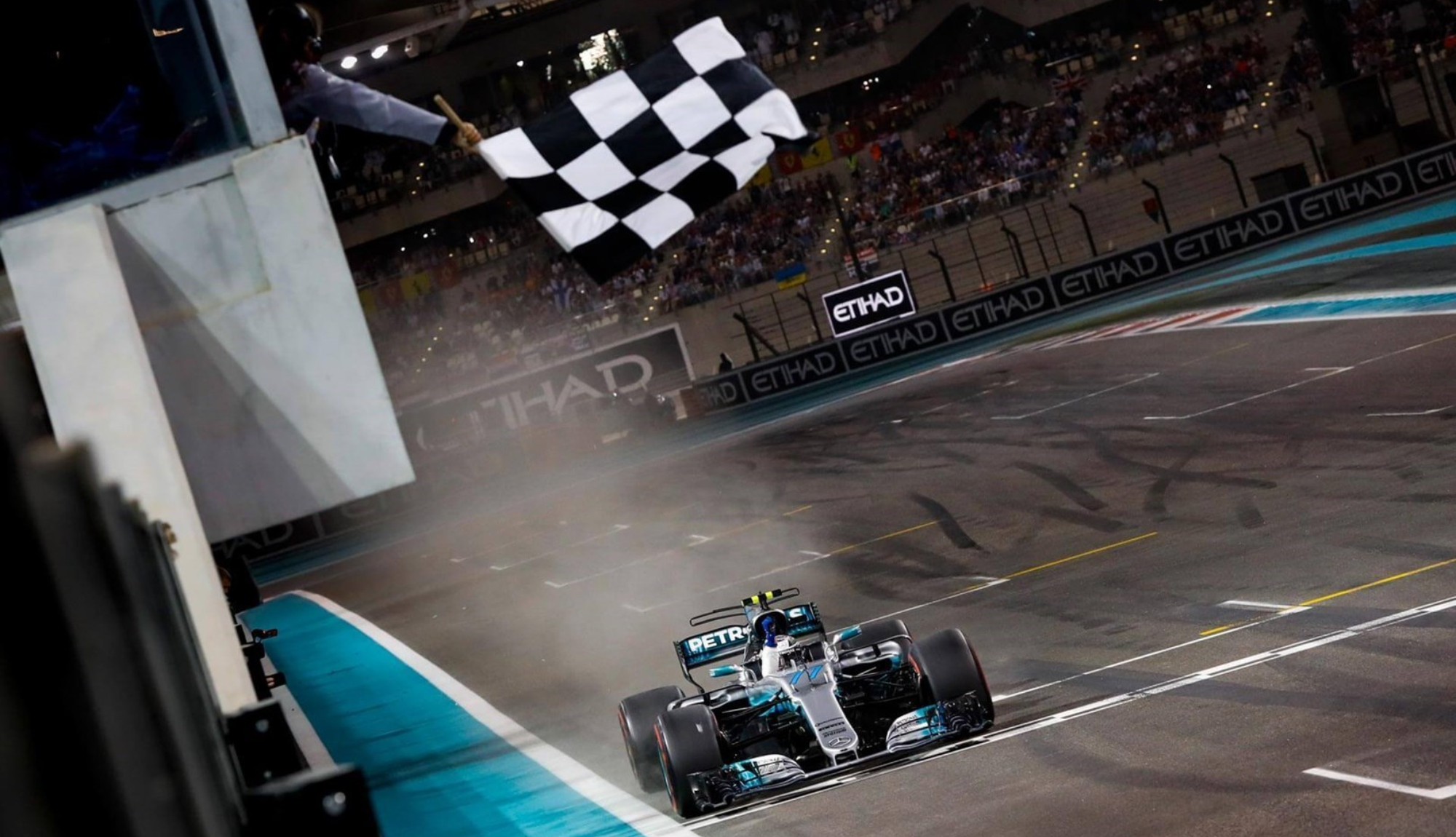 Car taking the chequered flag during the Abu Dhabi Grand Prix