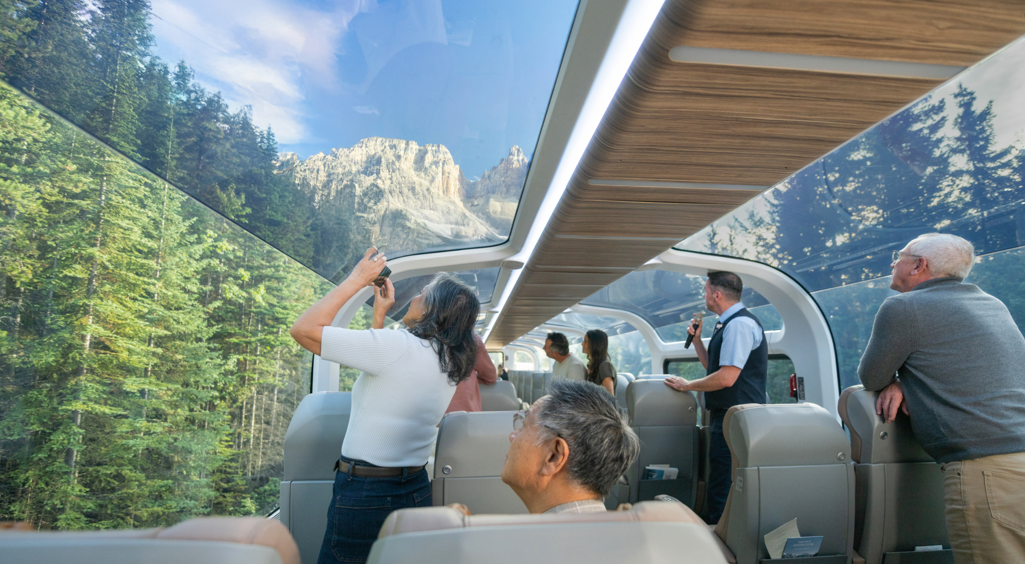 Rocky Mountaineer - Guests looking at scenery from their seats in GoldLeaf