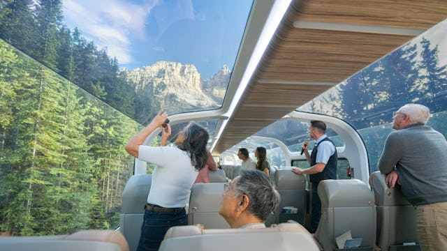 Rocky Mountaineer - Guests looking at scenery from their seats in GoldLeaf