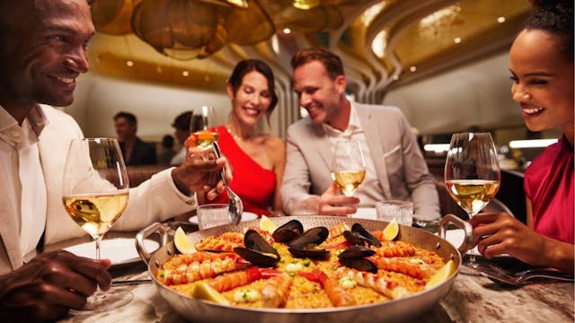 4 people enjoying paella onboard Celebrity Cruises