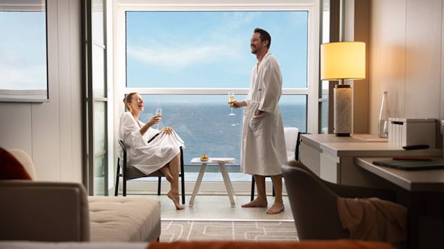 Couple enjoying champagne on their infinite veranda