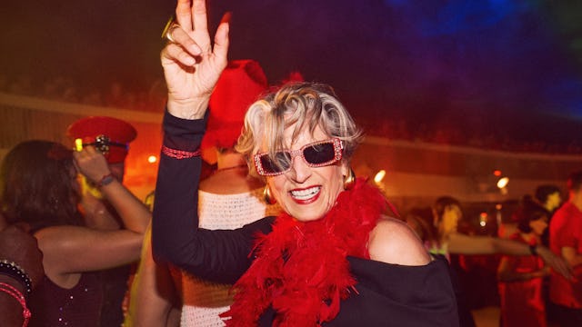 Woman dancing in red at Scarlet Nights pool party