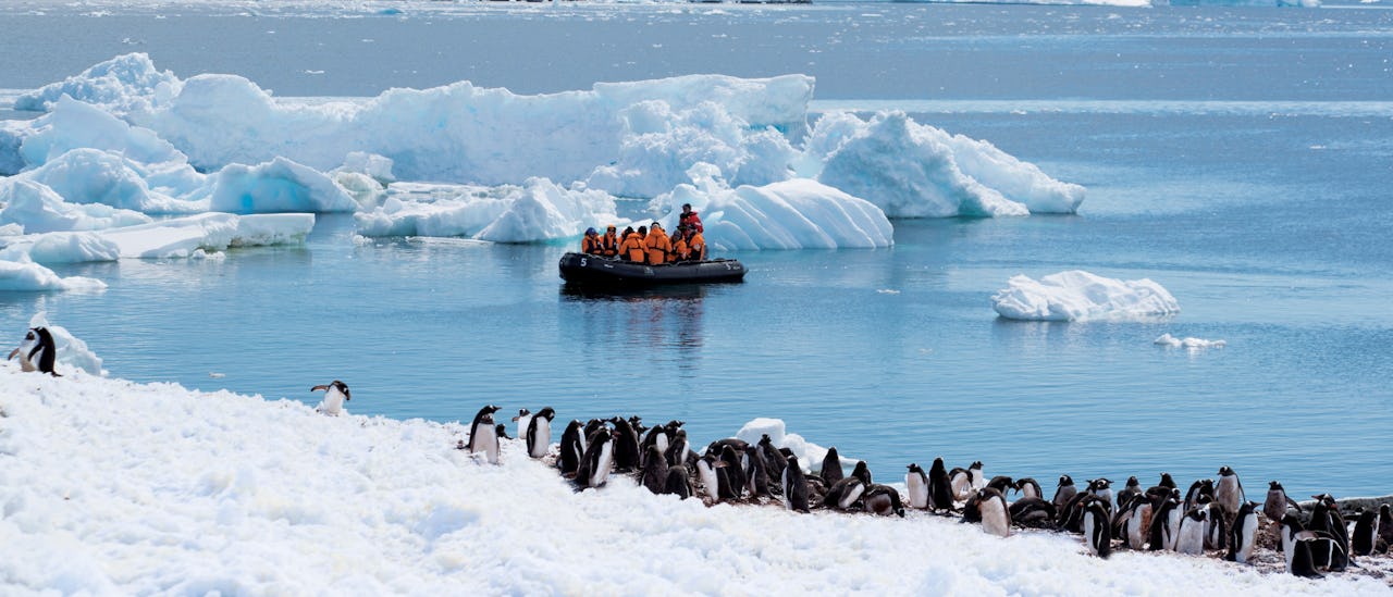 Guests onboard a Zodiac in Antarctica on a Seabourn cruise