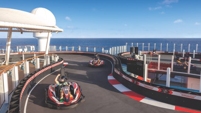 Guests driving go-karts on NCL Encore Speedway