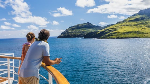 Couple taking in the scenery from top deck in Hawaii