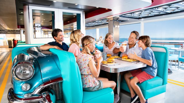 Family enjoying food at the American Diner onboard NCL Encore