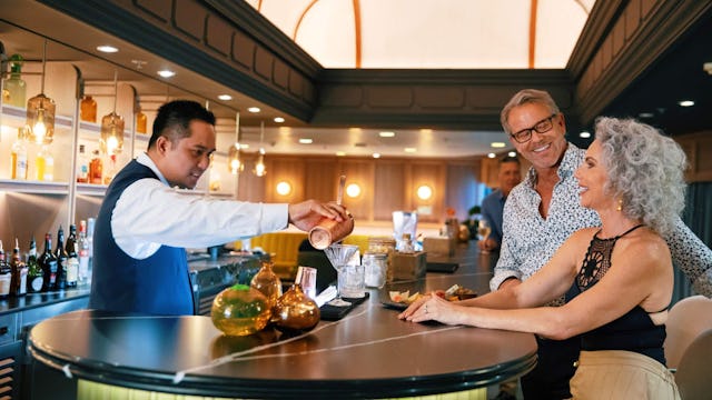 Couple enjoying cocktails in the Atlas Bar