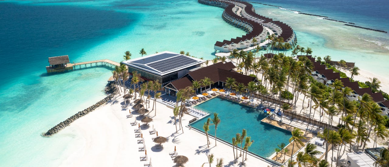 The pool bar and beach at OBLU Xperience Ailafushi in the Maldives
