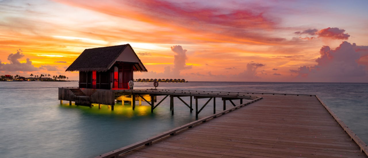 Arrival pier at the OBLU Xperience Ailafushi at sunset